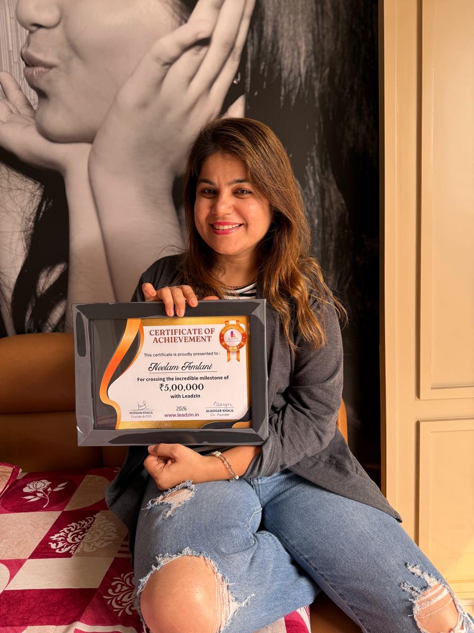 Neelam Amlani holding her certificate of achievement